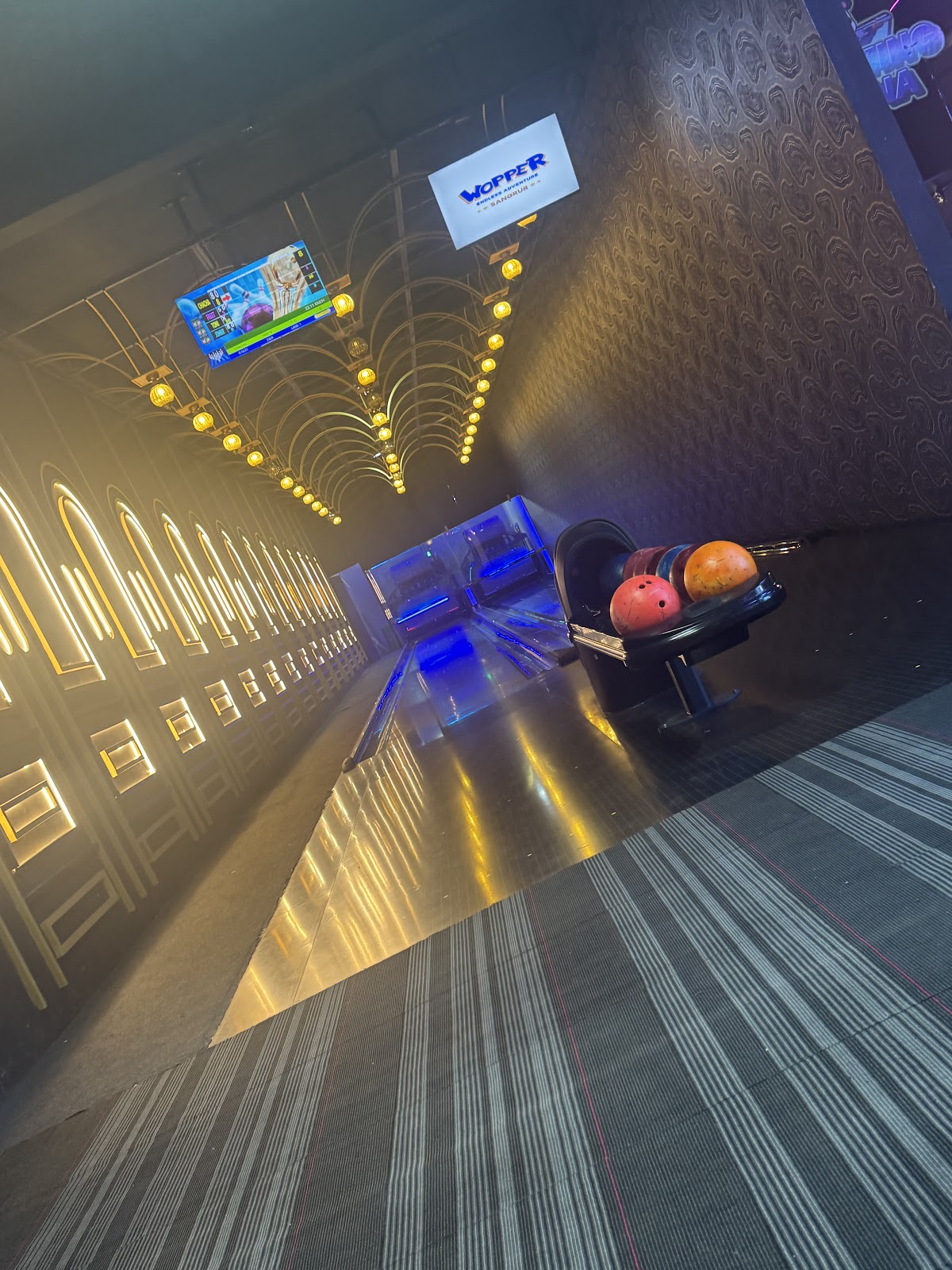 Bowling alley with balls in ball return rack