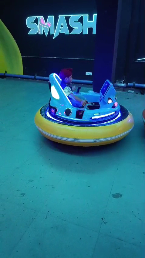 Bumper car in arena under Smash neon sign