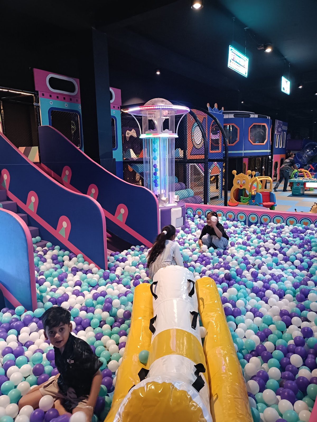 Children playing in sea of colorful pit balls