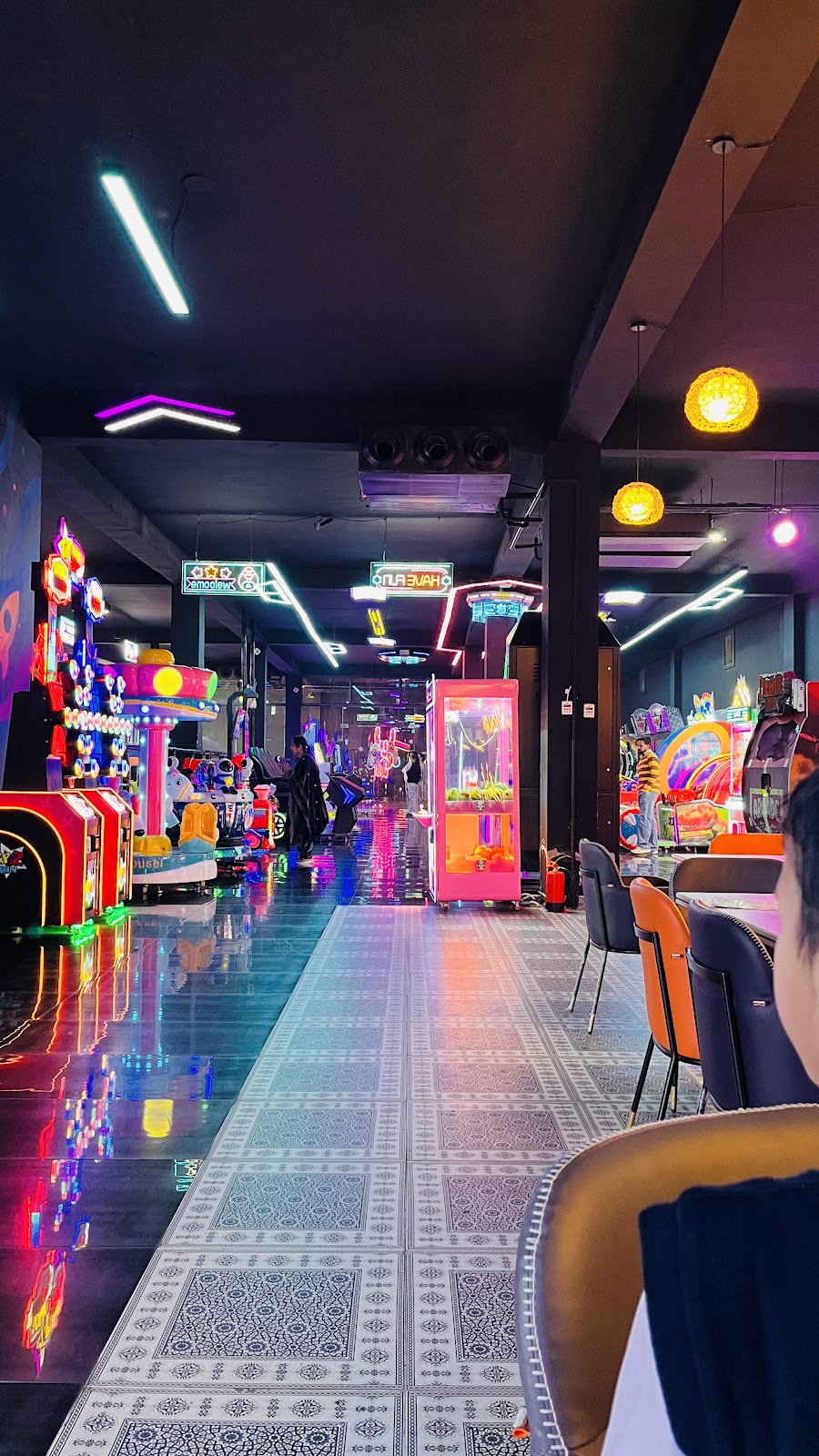 Illuminated promenade between cafe and arcade games