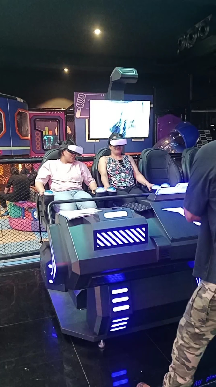 Adults experiencing virtual reality motion simulator