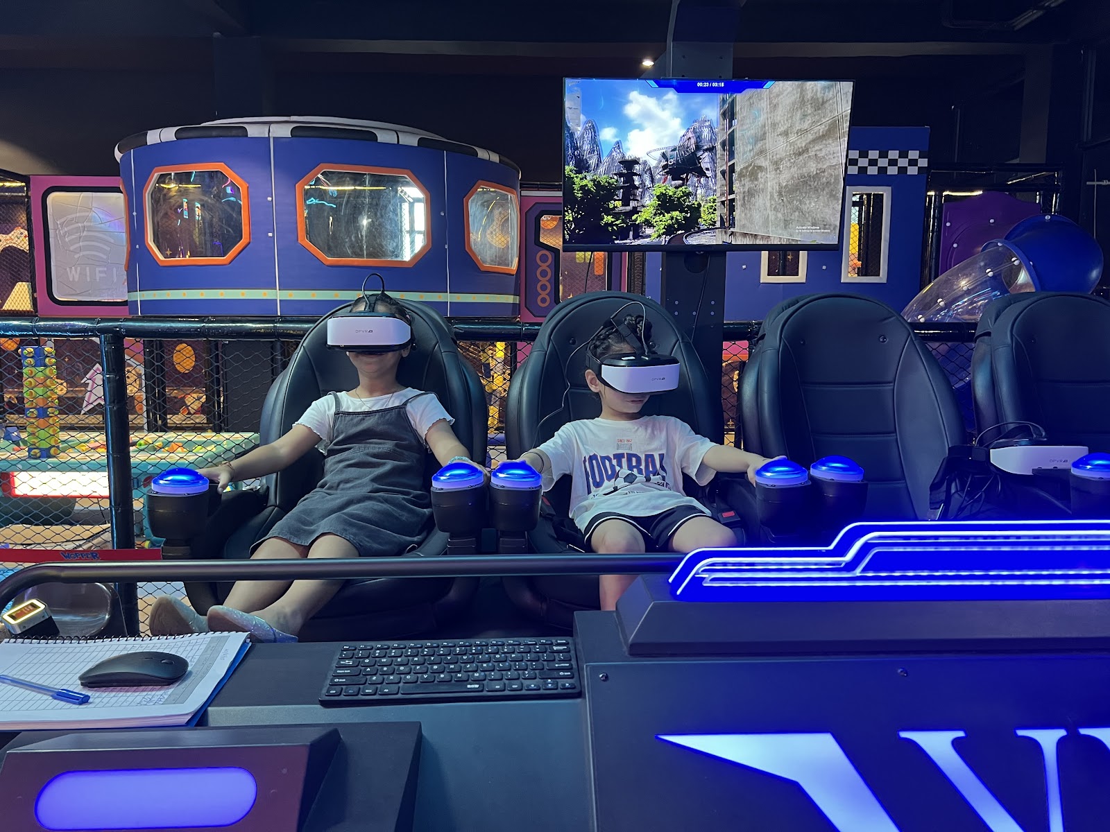 Kids enjoying VR simulator motion ride with headsets